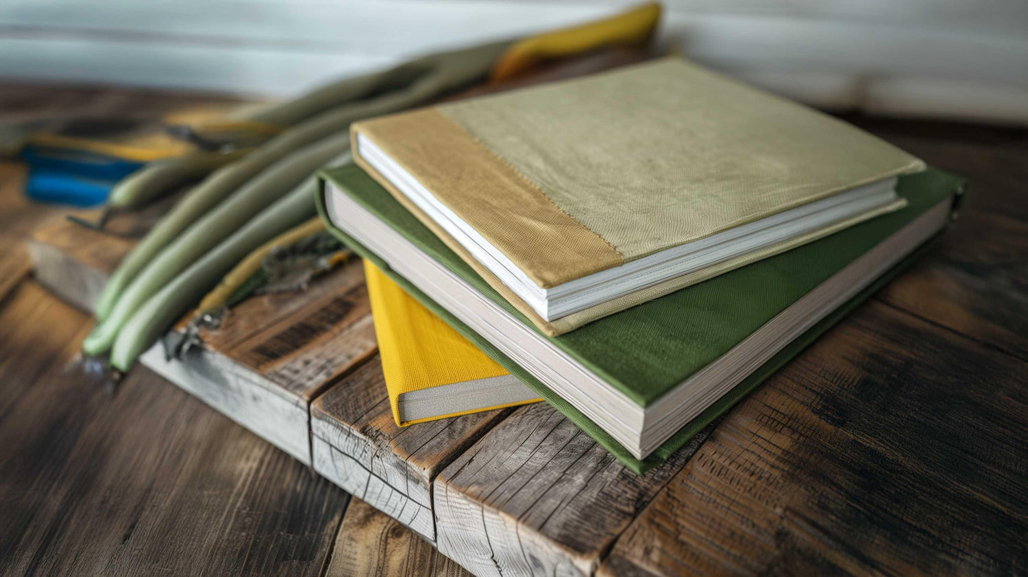 Stack of colorful hardcover books on rustic wooden table, ideal for academic and technical reading